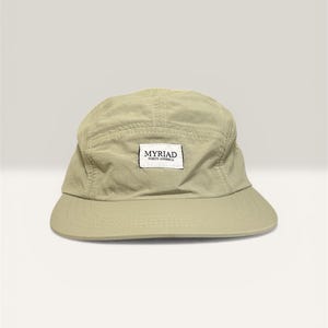 May include: A trio of ceramic mugs with a speckled, matte finish in cream, light grey, and dark grey. Each mug features a simple, minimalist design, ideal for tea or coffee.