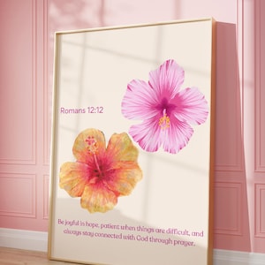 May include: A printable wall art design featuring two pink and orange hibiscus flowers with a white background. The text "Romans 12:12" and a quote about hope, patience, and prayer are included.