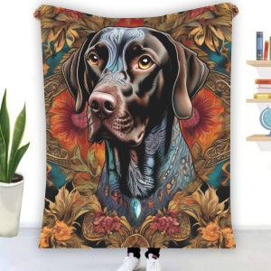 May include: A black and brown dog with a colourful tattoo design is featured on a throw blanket. The blanket has a floral pattern with gold accents.