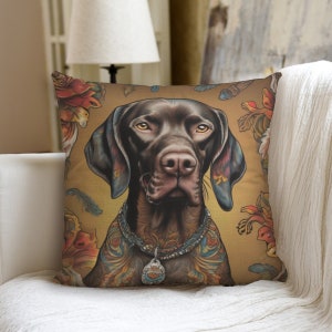 May include: A brown and black dog with a tattoo on its chest and a beaded collar. The dog is looking directly at the camera. The background is a yellow and gold color with floral designs.