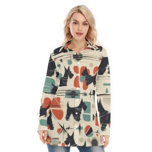 May include: A cream-coloured button-down shirt featuring a repeating pattern of black Scottish Terrier dogs, teal, orange, and grey geometric shapes. The long-sleeved shirt has a collared neckline and is buttoned down the front.