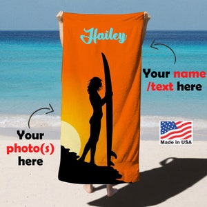 May include: Orange beach towel featuring a silhouette of a person surfing against a sunset backdrop. The towel has the text "Hailey" and "Your name/text here" printed on it. Made in USA.