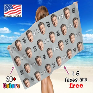 May include: A grey beach towel with a repeating pattern of faces and the text "Best Dad Ever". The towel is being held by a person. 20+ colours are available. 1-5 faces are free.