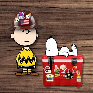 May include: Illustration of Charlie Brown wearing a brown hard hat with stickers, including a Taco Bell logo and an American flag. Snoopy is relaxing on a red cooler covered in stickers. The cooler has the text "Pizza Slut" and "Make That Bread".
