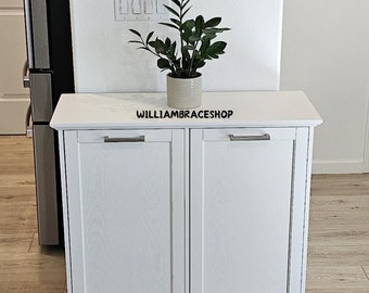 The tilting trash cabinet White, freestanding wooden garbage cabinet for the kitchen and dining area