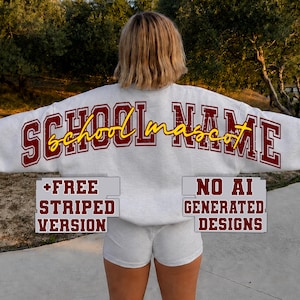 May include: A light gray crewneck sweatshirt featuring the text SCHOOL NAME in distressed dark red block letters with the word school mascot in yellow cursive script. Two gray rectangular text boxes read +FREE STRIPED VERSION and NO AI GENERATED DESIGNS.