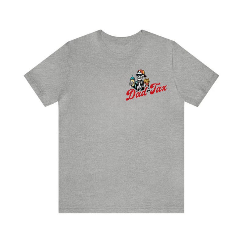 May include: A heather gray t-shirt featuring a skeleton wearing a hat and holding food and a drink. The text "Dad Tax" is printed in red cursive on the shirt. The shirt is a casual, everyday wear item.