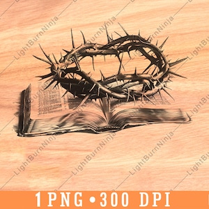 May include: A black and white illustration of a crown of thorns on top of an open book. The book is on a wooden surface.