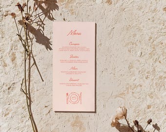 May include: A rectangular light pink menu card with dark pink text listing courses including canapes, starter, main, and dessert, accompanied by a fork, plate, and knife icon. Two dried flower stems with pale petals are positioned on either side.