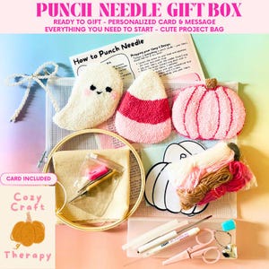 May include: A punch needle gift box with a variety of craft supplies. The kit includes a wooden embroidery hoop, punch needle tools, yarn, scissors, and a card. The box features a ghost, candy corn, and pumpkin designs.
