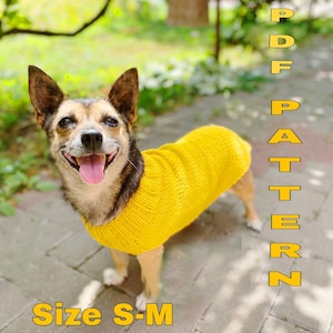 May include: A small dog wearing a yellow knitted sweater. The dog is looking at the camera and smiling. The text "PDF PATTERN" and "Size S-M" is visible in the image.