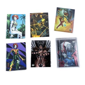 May include: A collection of six trading cards featuring comic book art. The cards display various female characters in action poses, with vibrant colors and detailed illustrations. Some cards have the word "Velocity" printed on them.
