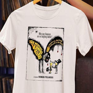 May include: White t-shirt featuring a black and white illustration of a vampire with the text "The Fearless Vampire Killers" and "Who says Vampires are no laughing matter?"  A film by Roman Polanski.