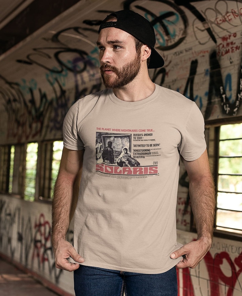 Young man wearing a customized sand cotton T-shirt from the movie Solaris  by  Tarkovski
