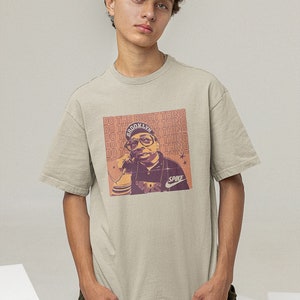 Young man wearing a sand cotton T-shirt Spike Lee Inspired