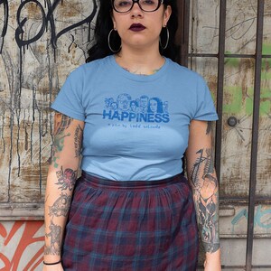 Young woman wearing a customized blue cotton T-shirt from the movie Happiness by Todd Solondz