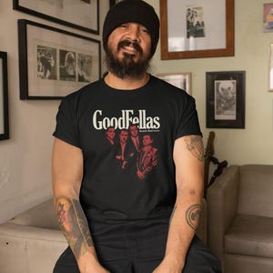 Young man wearing a customized black cotton shirt from the movie Goodfellas by Martin Scorsese