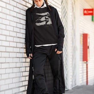 Young man wearing a customized black cotton sweatshirt from the movie Stalker  by  Tarkovski