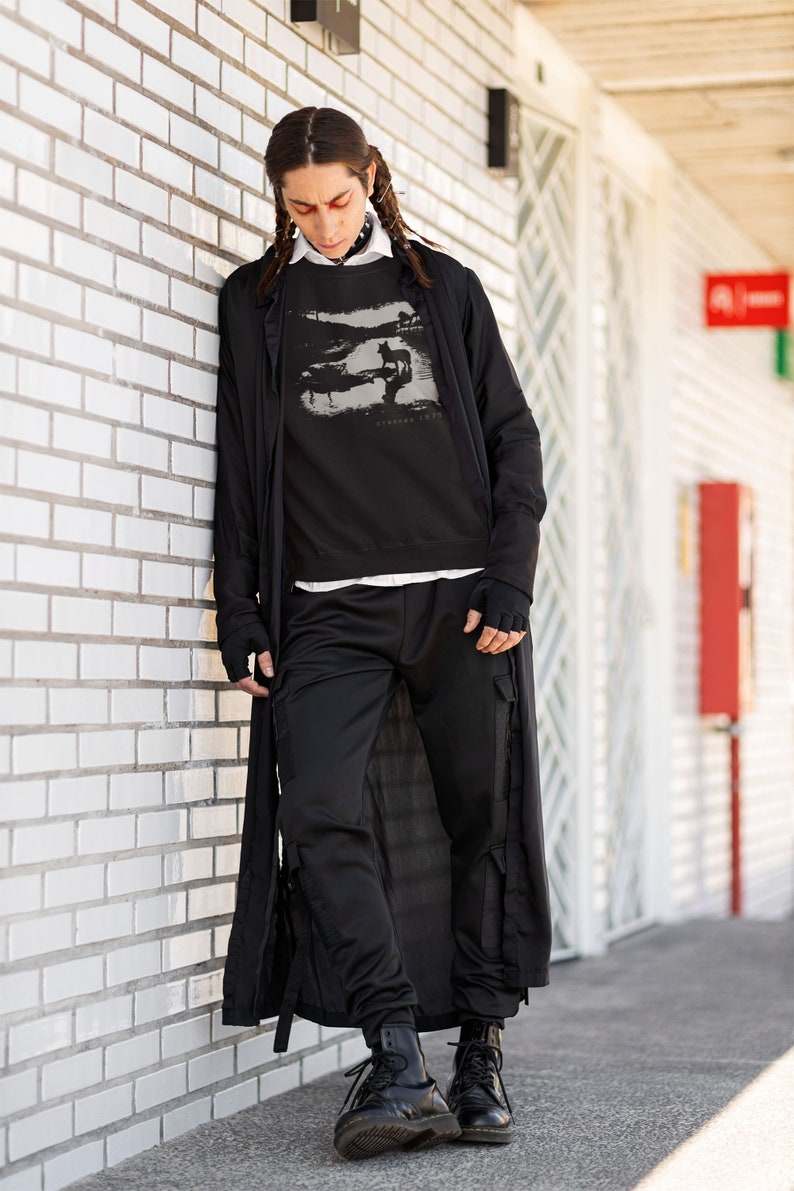 Young man wearing a customized black cotton sweatshirt from the movie Stalker  by  Tarkovski