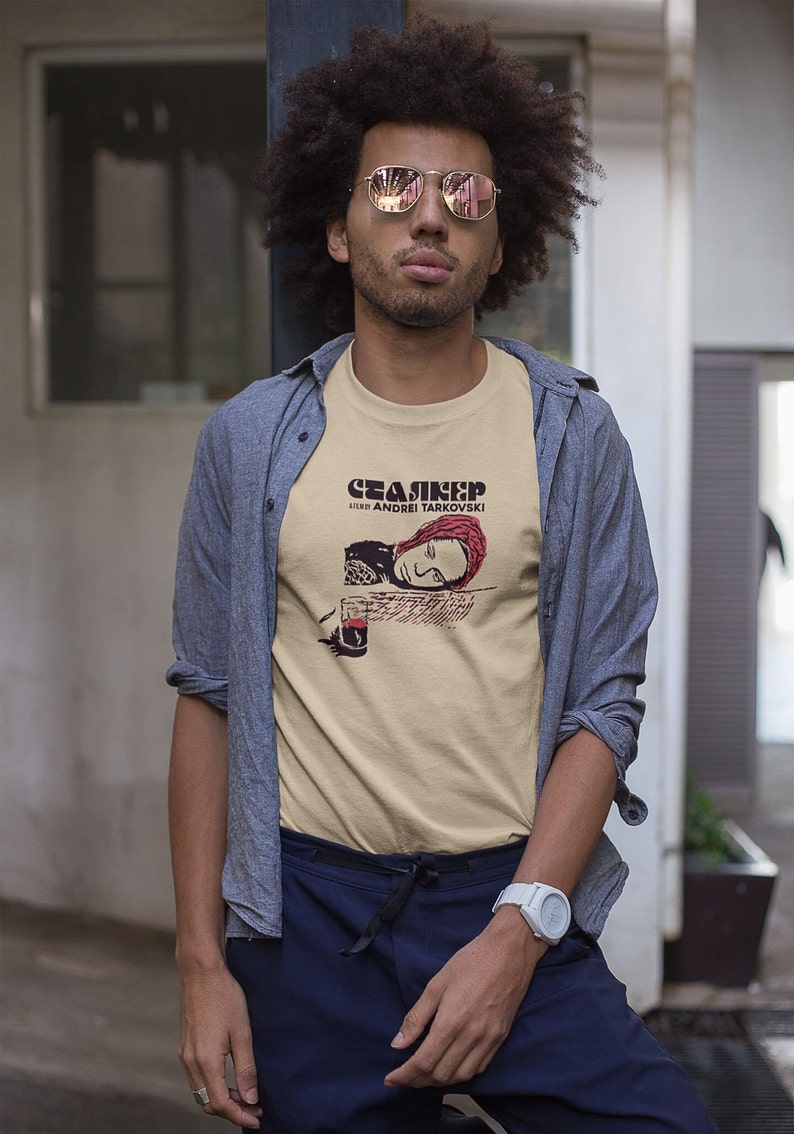 Young black man wearing a customized sand cotton T-shirt from the movie Stalker  by  Tarkovski