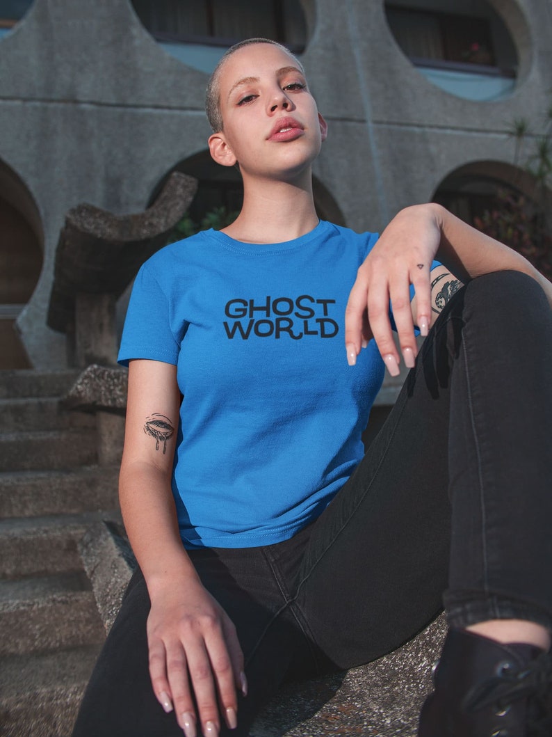 Young woman wearing a customized blue cotton shirt from the movie Ghost World by Terry Zwigoff