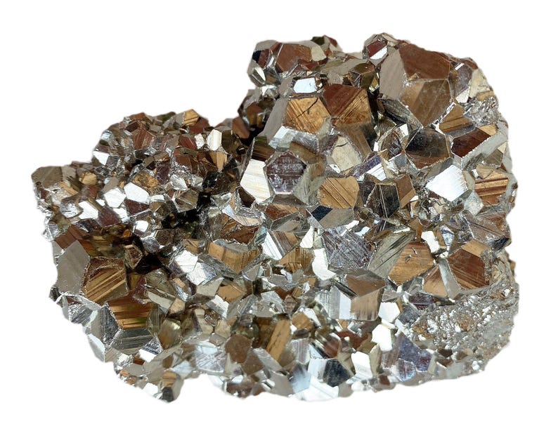 May include: A cluster of pyrite crystals, also known as fool's gold, with a metallic, reflective surface. The crystals are a mix of silver, gold, and bronze tones, with sharp, geometric shapes. The overall form is irregular and textured.