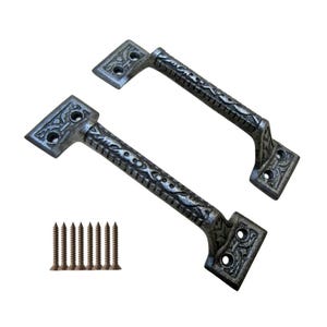 May include: Two antique-style, silver-colored door handles with ornate detailing and a set of matching screws. The handles have a rectangular base with rounded edges and a curved grip, perfect for cabinets or drawers.