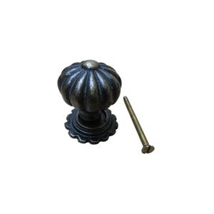 May include: A bronze-colored cabinet knob with a pumpkin-shaped design. The knob has a decorative base and is accompanied by a matching screw. The hardware is suitable for furniture restoration or new builds.