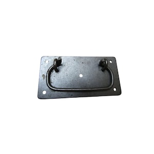 May include: A rectangular, dark gray metal drawer pull with a curved handle. The pull has a distressed finish and four screw holes, with a single hole in the center. The handle is attached with two loops.