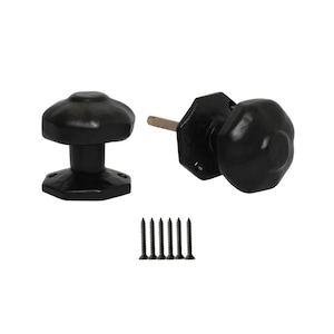 Könnte beinhalten: Schwarze Türknöpfe mit klassischem Design. Das Set enthält zwei Knöpfe, einen mit Stiel und Montageplatte sowie einen passenden Knopf. Sechs schwarze Schrauben sind ebenfalls enthalten. Die Knöpfe haben eine traditionelle, abgerundete Form.