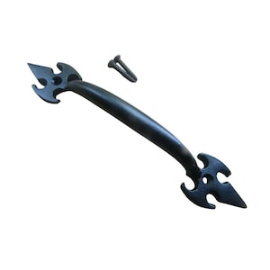 May include: Black metal handle with decorative arrow-shaped ends and a curved bar. Includes two screws for installation. The handle is designed for use on doors, drawers, or cabinets.