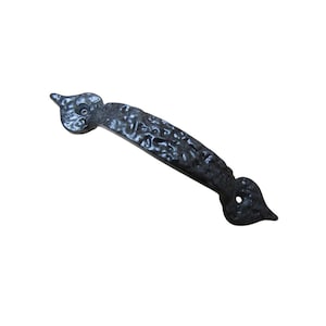 May include: A black, textured metal handle with a hammered appearance. The handle has a curved design with decorative, leaf-shaped ends and a central grip. The handle is approximately 6 inches long.