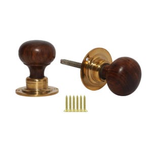 May include: Two wooden door knobs with brass hardware and a set of screws. The knobs are a dark brown color and have a rounded shape. The brass hardware has a gold color and a circular shape.