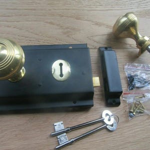 6'' Rim Lock Black & Regency Rimmed Brass Knob Set