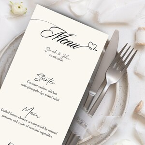 May include: A wedding menu with the title "Menu" in cursive script, followed by the names "Sarah & John" and the date "20.08.2030". The menu lists a starter of "Coconut cashew chicken with pineapple dip, mixed salad" and a main course of "Grilled lemon chicken accompanied by roasted potatoes and a side of seasonal vegetables."