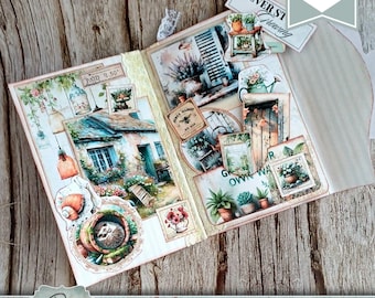 May include: An open junk journal kit with a green garden theme. The pages feature vintage-style illustrations of a cottage, plants, and garden elements. The kit includes decorative tags and the text "Green Garden Junk Journal Kit".