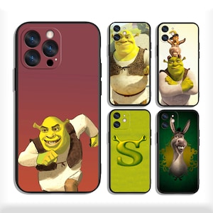 May include: Set of six phone cases featuring different images of Shrek and Donkey from the Shrek movie franchise. The cases are black with a clear plastic window showing the image. The images include Shrek running, Shrek and Donkey standing together, Shrek and Donkey with a dragon, Shrek with a sword, Donkey with a crown, and Shrek with a letter 'S'.