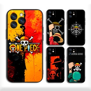 May include: Five smartphone cases featuring One Piece anime designs. One case has a large yellow and red paint splatter background with the One Piece logo. Four smaller black cases display character illustrations, skull emblems, and compass motifs.