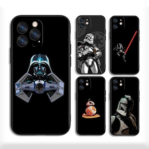 May include: Black phone cases with Star Wars designs. The cases feature Darth Vader with a TIE fighter, a Stormtrooper, Darth Vader with a lightsaber, BB-8, and a Mandalorian. Each case has a black border and a glossy finish.