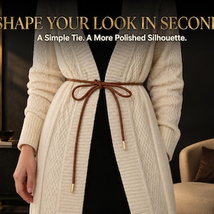 May include: A thin brown cord belt tied in a bow around a long cream-colored cable-knit cardigan. The text SHAPE YOUR LOOK IN SECONDS and A Simple Tie. A More Polished Silhouette. is visible at the top of the image.