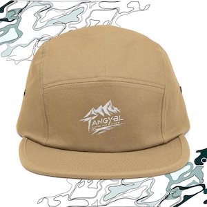 May include: A tan 5-panel cap with a white embroidered logo that says "Tangybl Custom Hat Co."