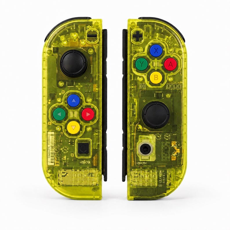 May include: A pair of neon yellow transparent game controllers featuring black joysticks and buttons. The left controller has a directional pad with blue, green, red, and yellow arrows. The right controller has four primary action buttons in blue, green, red, and yellow, plus a black plus sign button.
