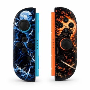 May include: A pair of game controllers featuring custom skins. The left controller has a blue side rail and a blue-toned graphic of a samurai with a sword and a full moon. The right controller has an orange side rail and an orange-toned graphic of a samurai with a sword and falling maple leaves.