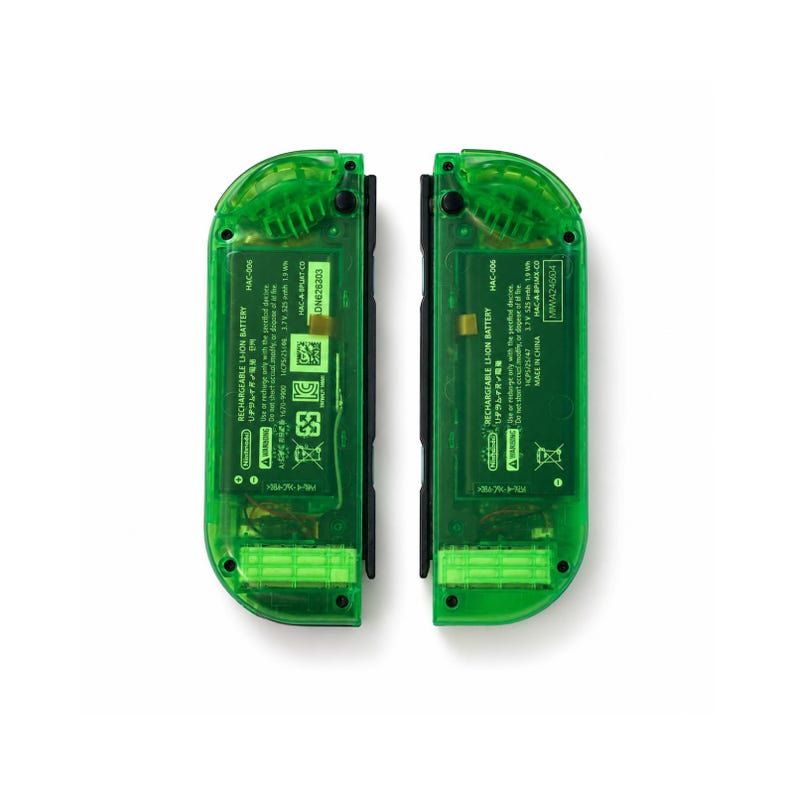May include: Two transparent green game controllers with black accents. Each controller has internal components visible through the green casing. Text on the controllers includes "RECHARGEABLE LI-ION BATTERY" and model numbers.