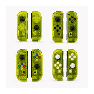 May include: Four pairs of neon yellow transparent game controllers. Each pair features a left and right unit with black or white joysticks, directional pads, and action buttons. The internal circuitry is visible through the translucent plastic shells.