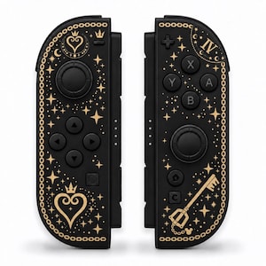 May include: A pair of black game controllers featuring gold-colored graphics including a heart with a crown, a key-shaped blade, the Roman numeral IV, and various star patterns, all bordered by a chain-link design on the outer edges.