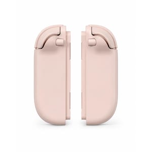 May include: A pair of pale pink gaming controller attachments featuring a smooth, rounded rectangular design with integrated shoulder buttons and triggers. These two matching components are positioned vertically, mirroring each other in a clean, matte finish.