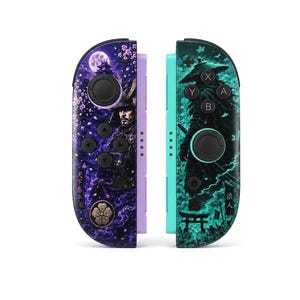 May include: A pair of game controllers featuring custom skins. The left controller is purple with a samurai, cherry blossoms, a full moon, and Japanese text. The right controller is teal with a silhouetted figure, a torii gate, and Japanese text.