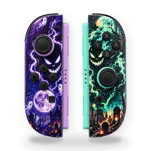 May include: Two game controllers featuring a Halloween-themed design. The left controller has a purple and black graveyard scene with a full moon, ghosts, and lightning. The right controller features a teal and black graveyard scene with a glowing moon.