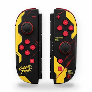 May include: A pair of black, yellow, and red game controllers featuring the text Cyberpunk, No Systems Just Us, and Night City Rebels. The controllers include red buttons, a black joystick, and a skull icon on the right-hand controller.